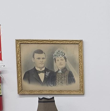 A framed nineteenth-century portrait of a couple, displayed in the museum parlor.