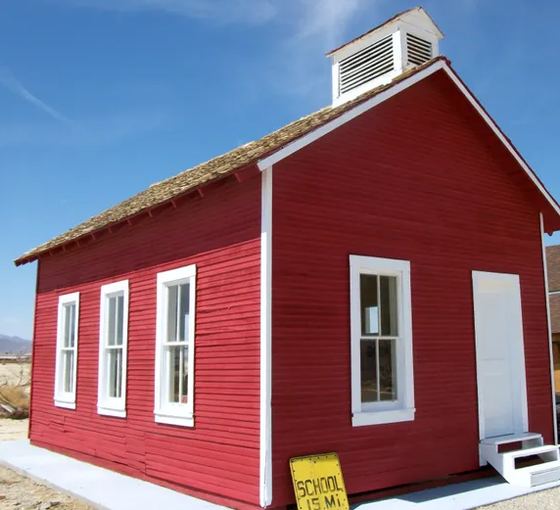 The one-room schoolhouse standing on the museum grounds.